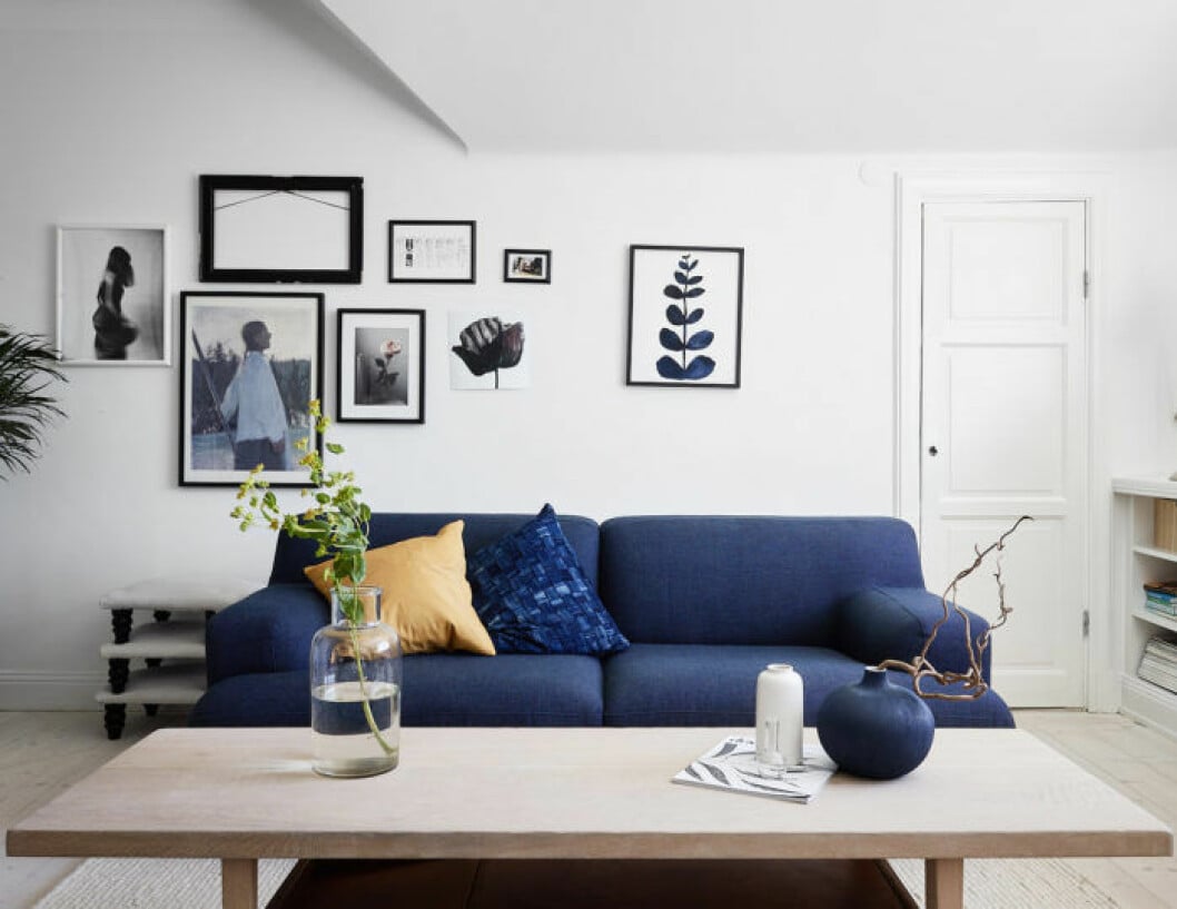 Blue couch and art wall in livingroom. Scandinavian decoration and ideas.