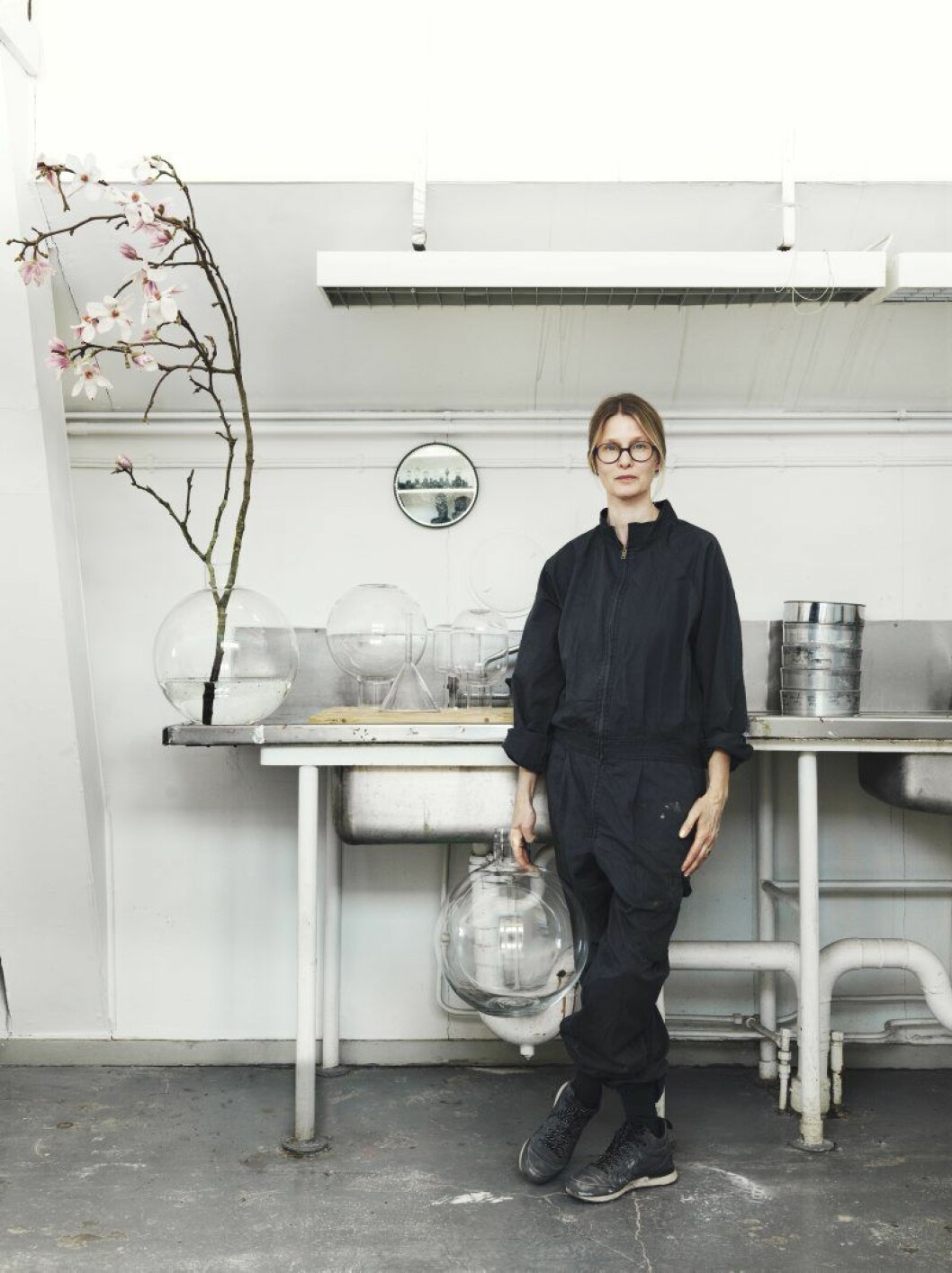 I Carina Seth Anderssons ateljé i Gustavbergs gamla chamottefabrik är det lagom svalt och mycket ljust: växterna stortrivs. Här vid diskbänken brukar hon kruka om och pyssla. Carina håller i sin egen vas Pallo. På bänken står även ett av glasen från samarbetet med svenska modeföretaget Hope. Pallo, från 3 000:-, Skrufs glasbruk. Carina seth andersson atelje