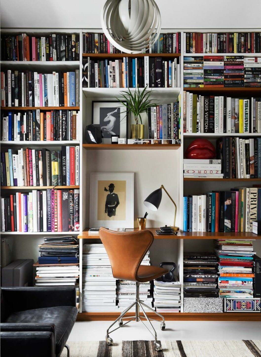 När Daniel precis köpt huset anlitade han Thomas Eriksson arkitekter för en platsbyggd bokhylla fyllda med fotoböcker, magasin och små accessoarer. Kontorsstol ur Sjuan-serien av Arne Jacobsen.