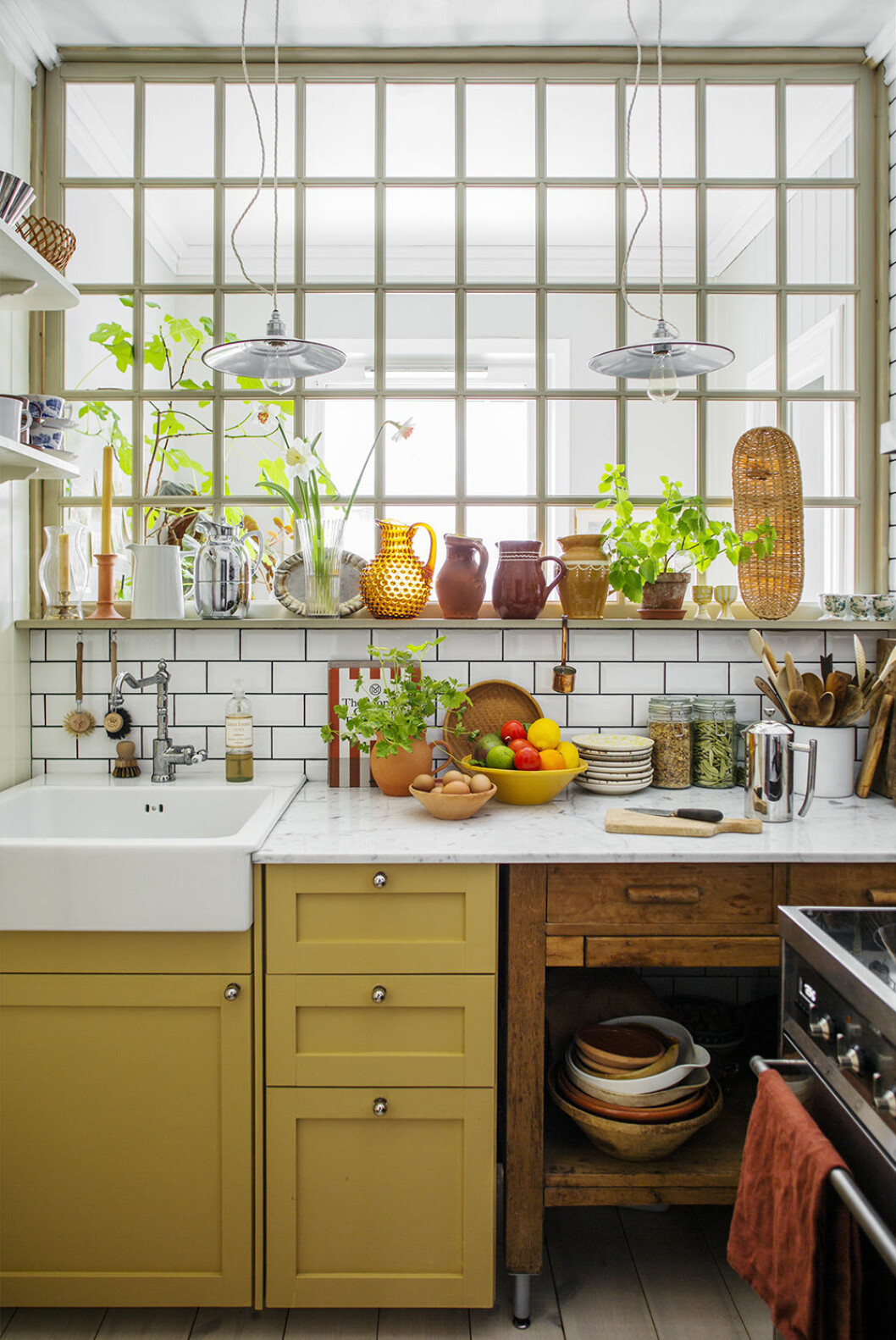 Kök målat i <em>Marpes 764</em> från Alcro som går fint ihop med ytor i såväl trä, marmor som rostfritt. Styling: Jill Windahl Foto: Lina Östling för Alcro Kök i trendigt gul färg