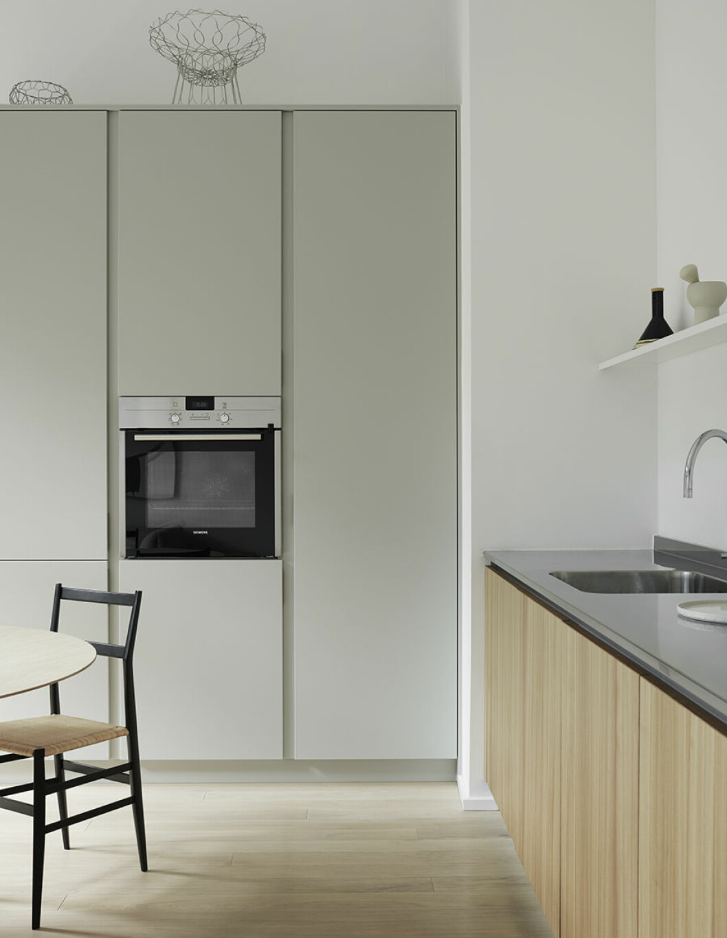 Kök i cederträ från Kvänum. Blandare från Dornbracht. Stålkorgar <em>Spirogira</em>, design Patricia Urquiola för Alessi. Vinflaska från Alberto Alessis vingård bredvid Alessis vita mortel i stengods. hans kök