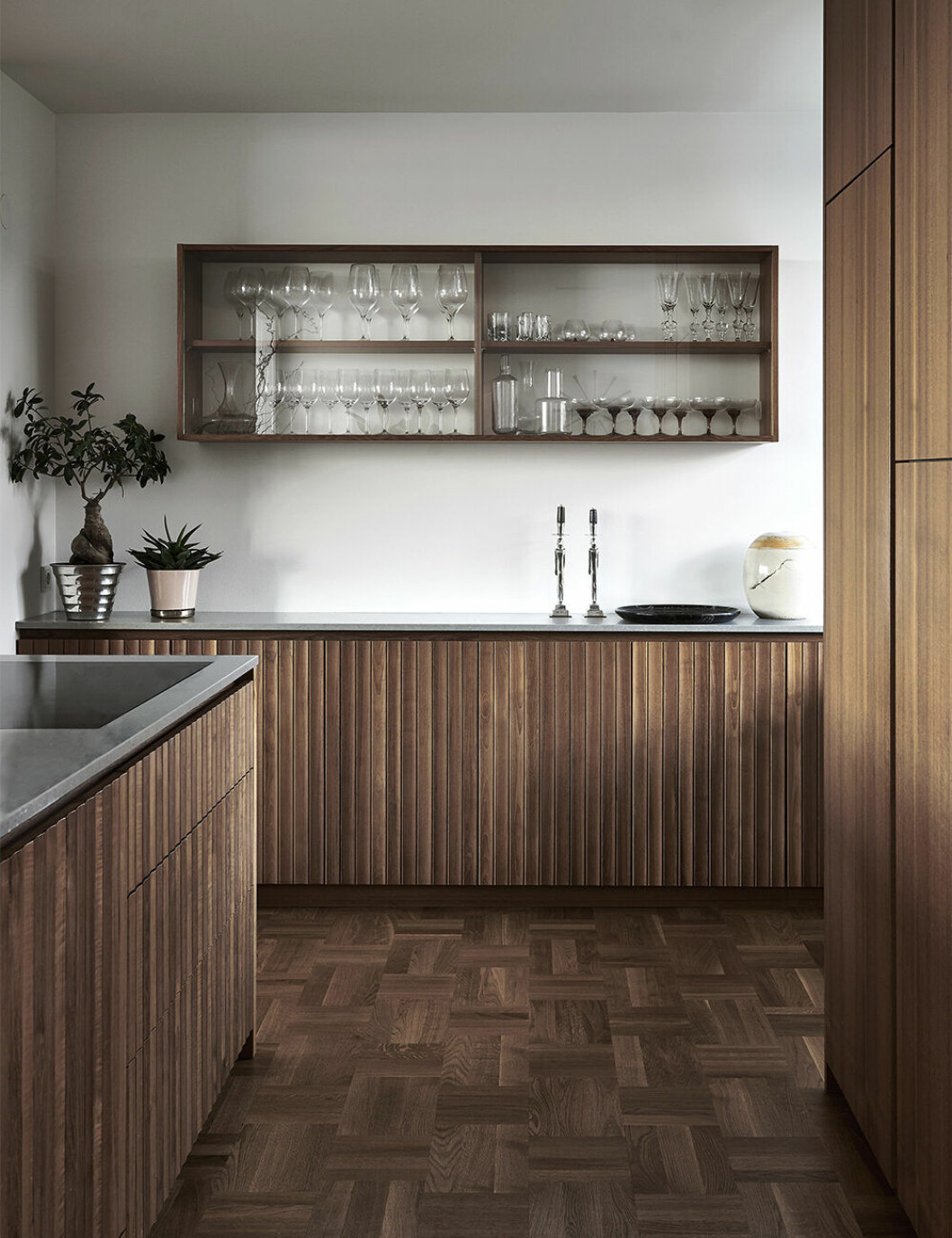 Kök ritat av Joanna och David och tillverkat av KFK Snickerier i teak. Vitrinskåpet är en nytolkning av ett platsbyggt original i huset. Ljusstakar och krukor, Svenskt tenn. Vas från hantverksbutik i Brasilien. Joanna Lavéns kök i hemmet på Lidingö