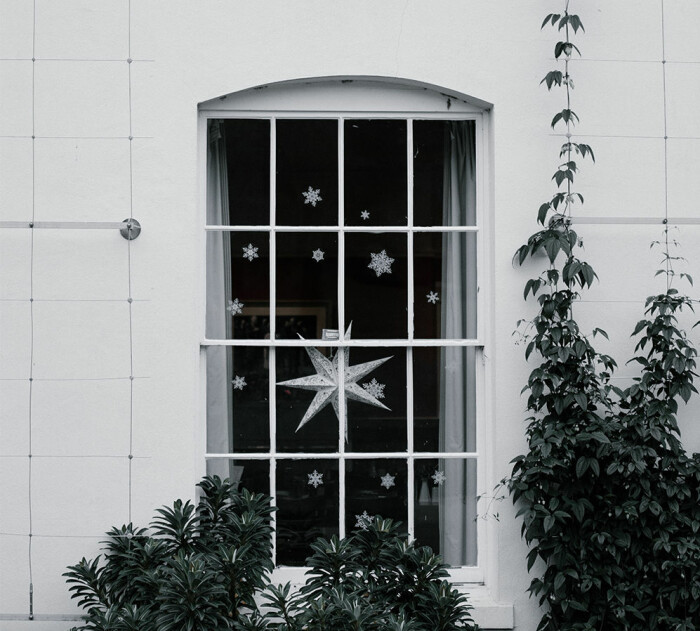Juldekorationer kan ge glädje både inne och ute! Foto: Unsplash juldekorerat fönster