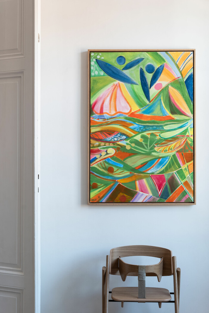 Alla barnstolar behöver inte vara i plats och plåt, utan det finns även de i snygg design som denna. Tavla med färgglatt motiv ovanför barnstol i snygg design