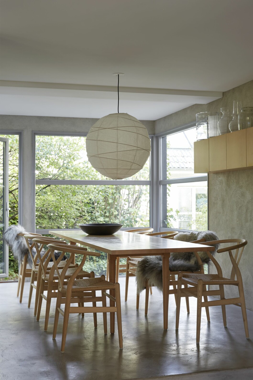 Matplatsen mot den vilda baksidan. Bord Oak av Jonas Lindvall. Y-stolar av Hans J Wegner. Rislampor från Den kinesiske butik i Köpenhamn. På hyllan Susannes samling av glasvaser, med allt från Ikea-vaser till Ingegerd Råmans klassiker. Matsalen i arkitektritade huset.