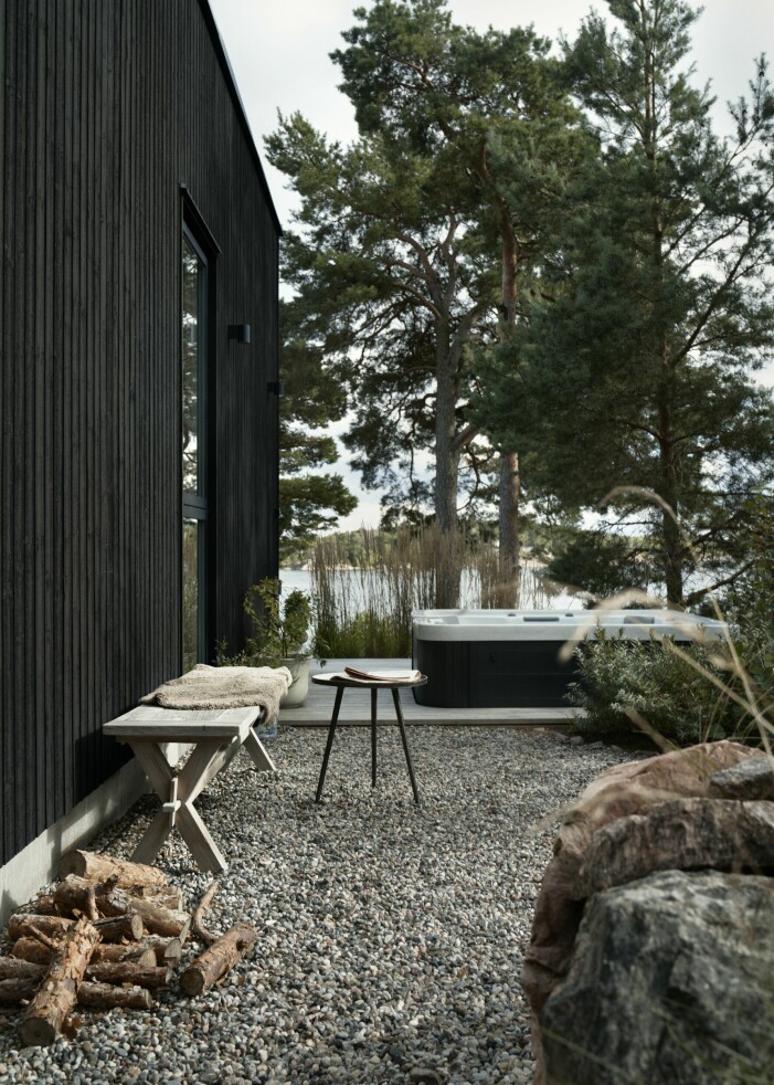 Huset har uteplatser i alla väderstreck utom nordväst. På bilden syns platsen som familjen döpt till »spa-sidan«. Bänk från Formlagret. Uteplats med spa-bad.